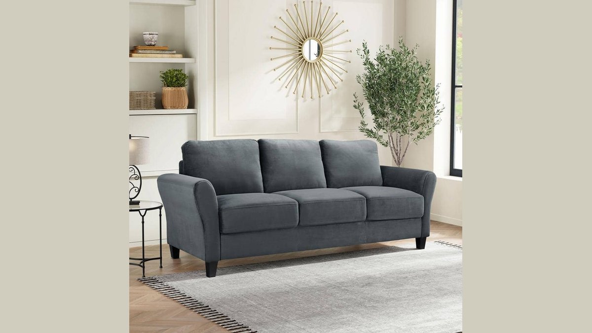 A modern 3 seater sofa serves as the centerpiece of a bright living room.