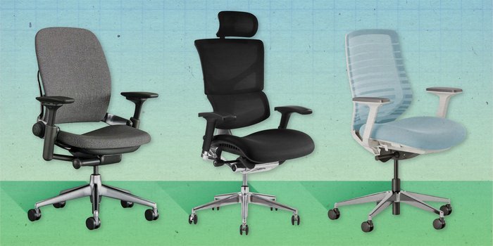 A modern ergonomic chair sits in a bright, minimalist office space ready for work.
