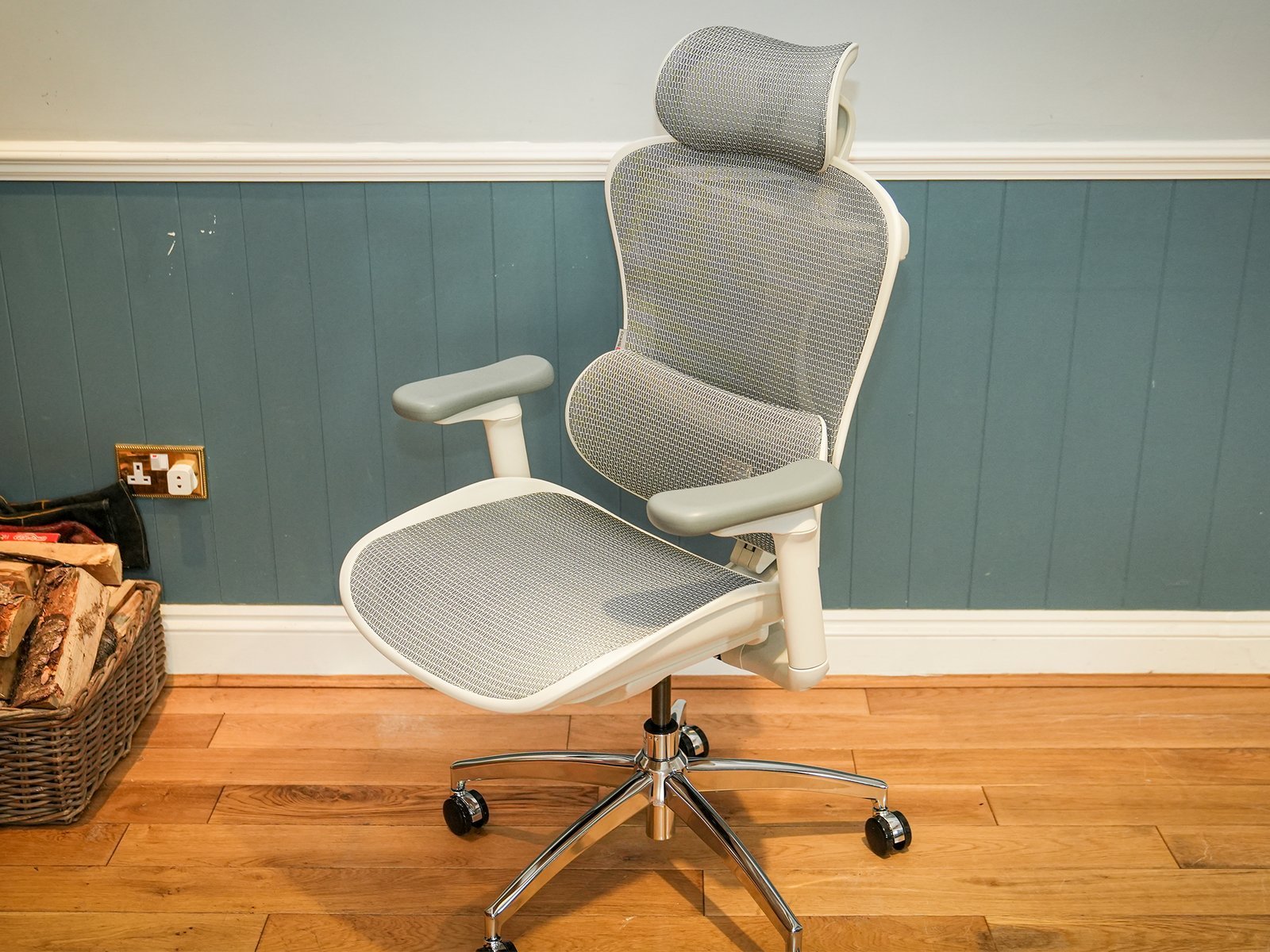 A person adjusting their ergonomic home office chair to achieve correct posture.