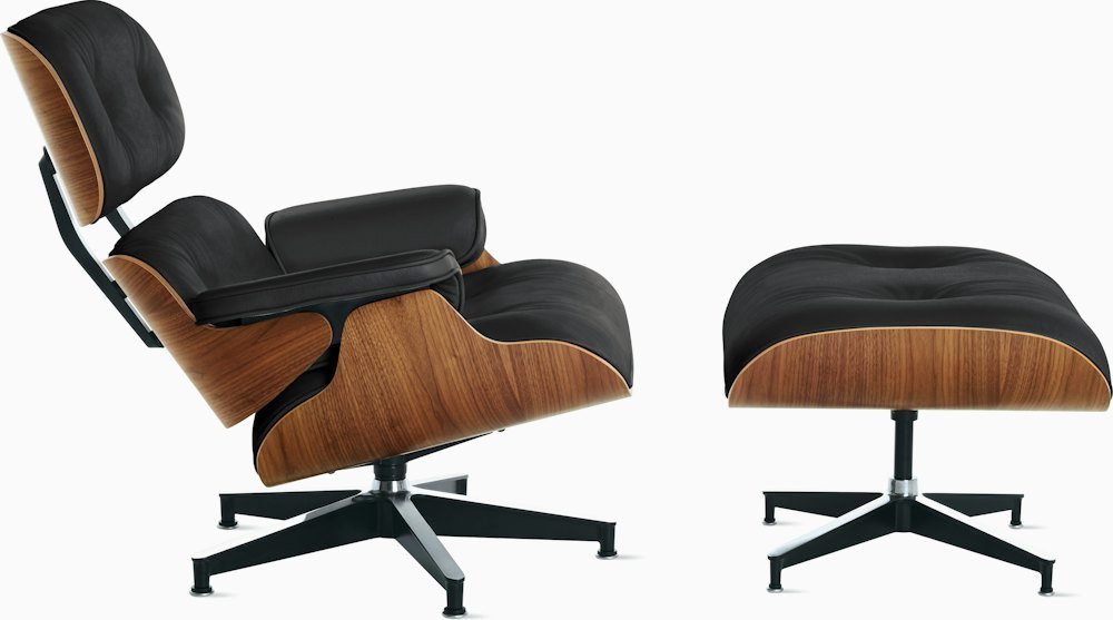 A sculptural mid-century modern lounge chair displayed in a clean, minimalist living room.