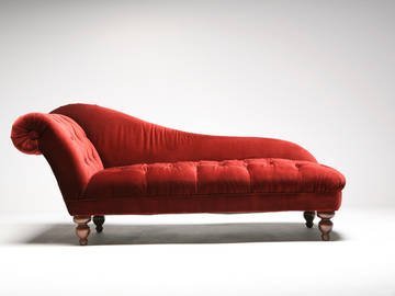 A stylish lounge chair sits in a bright, modern living room space.