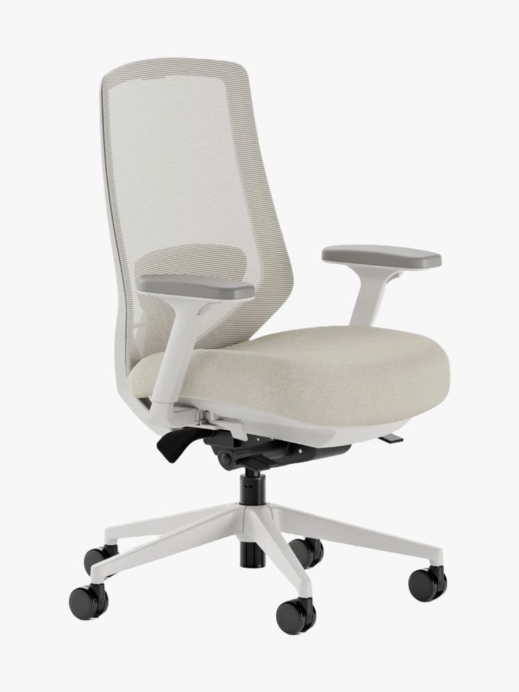 A clean and minimalist office workspace with a single ergonomic chair and laptop.