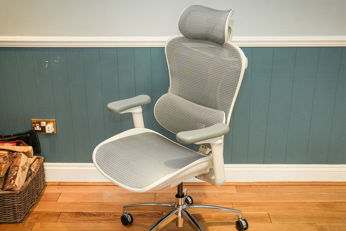 A person adjusting the seat depth and height on an ergonomic office chair.