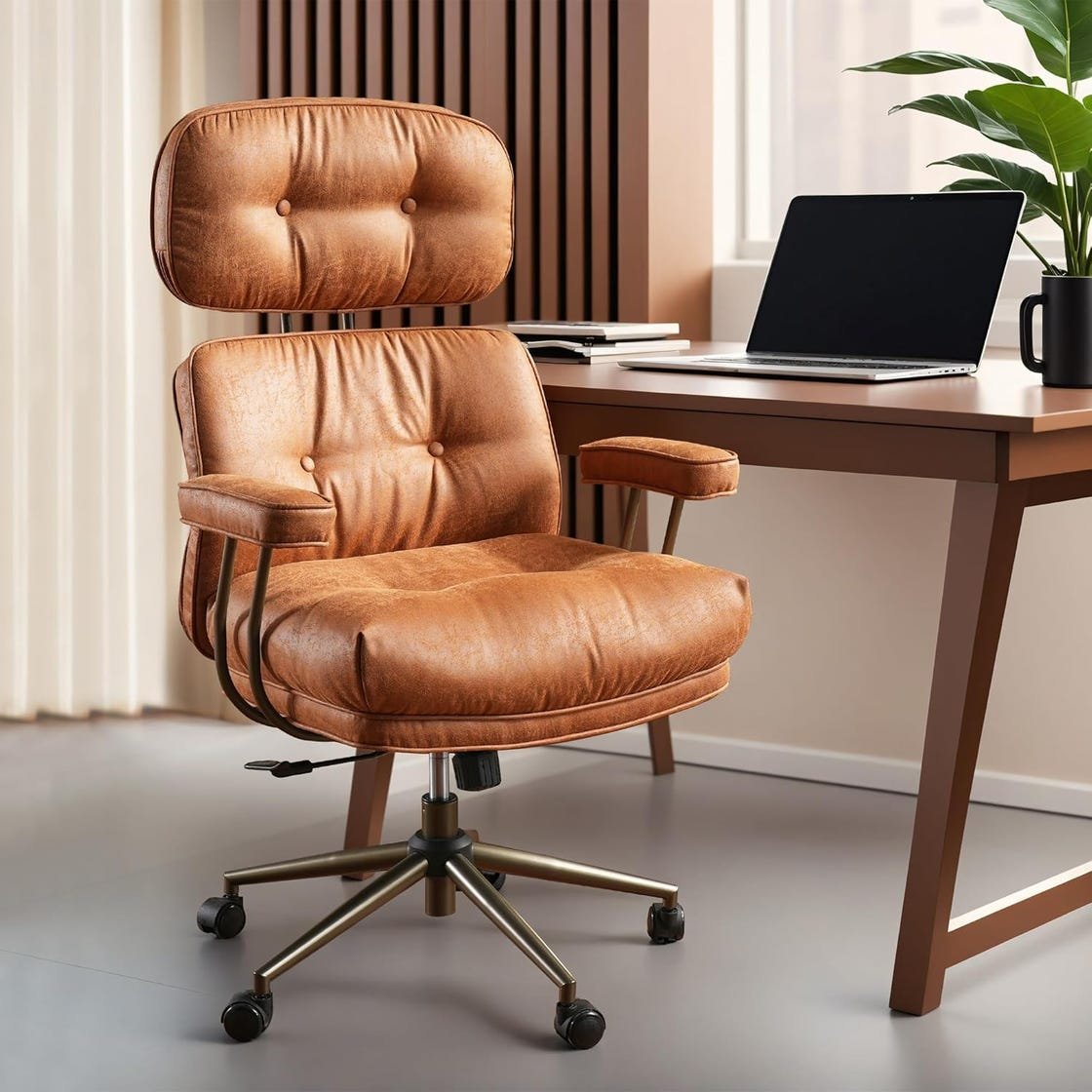 A person sitting with correct posture in an ergonomic office chair at their desk.