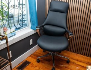A modern ergonomic office chair in a bright, clean, and comfortable home office.