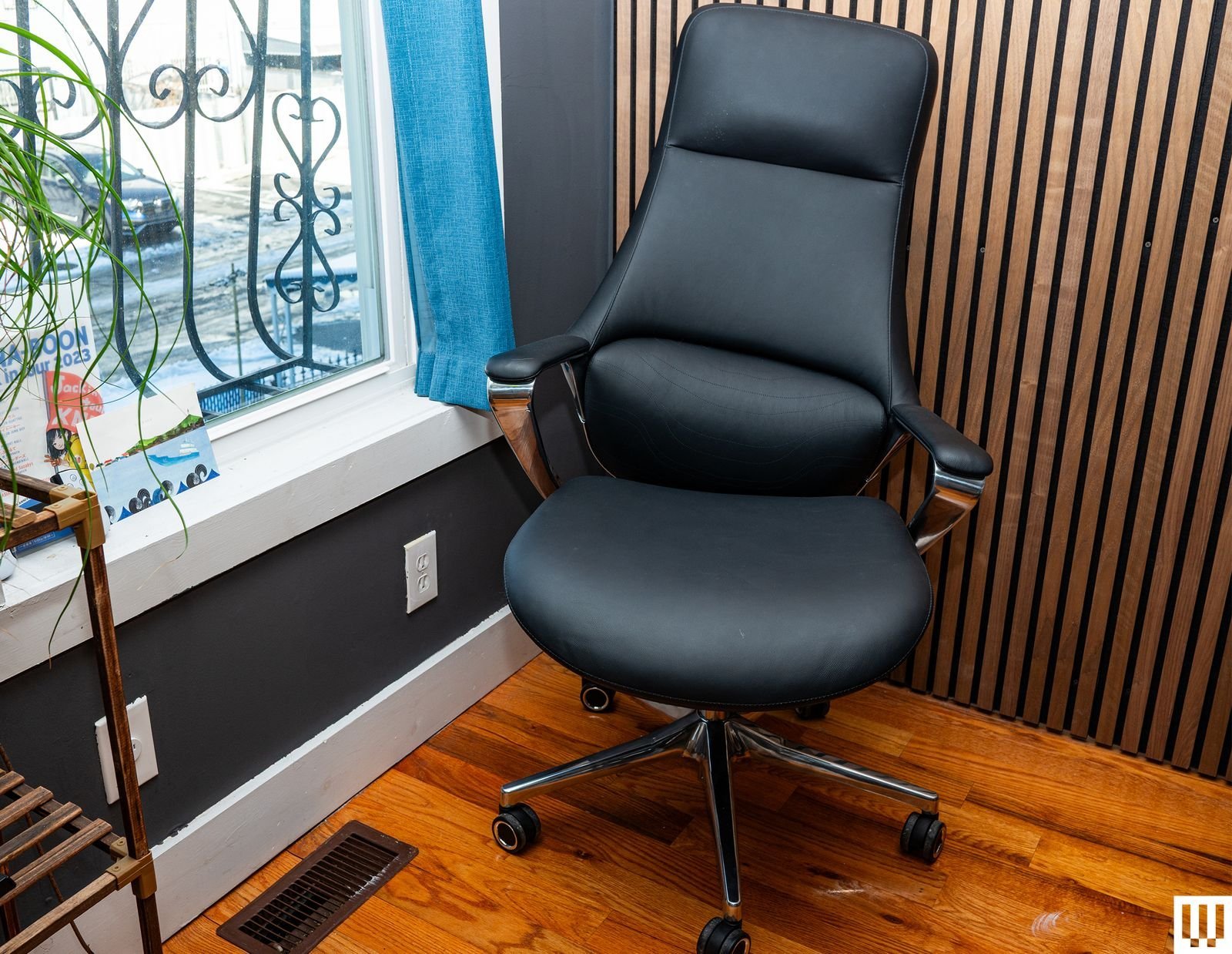 A modern ergonomic office chair in a bright, clean, and comfortable home office.