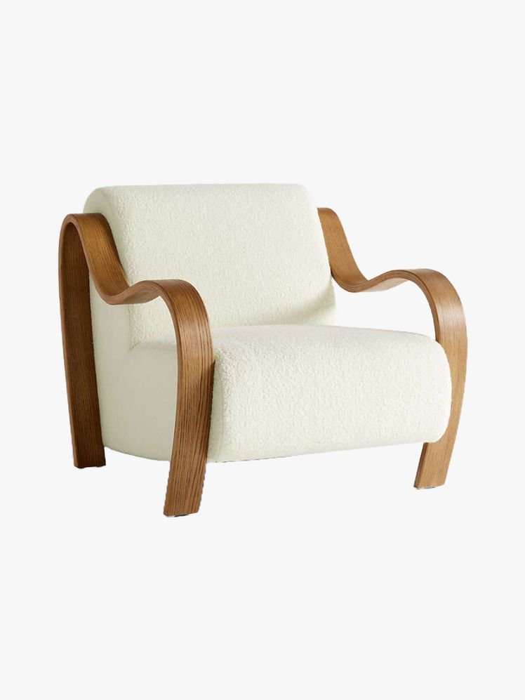 A person researching different styles and materials to find the perfect accent chair.