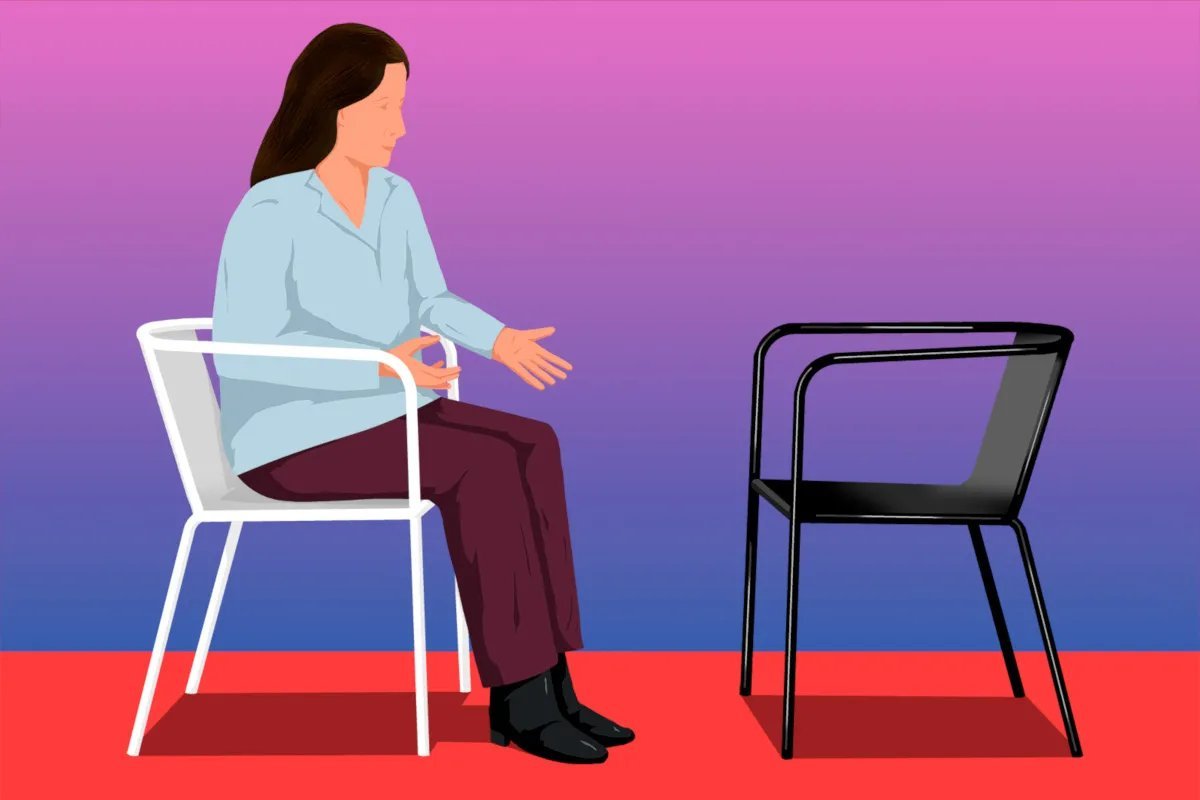 A person sitting on a chair practicing the two chair technique in sunlight.