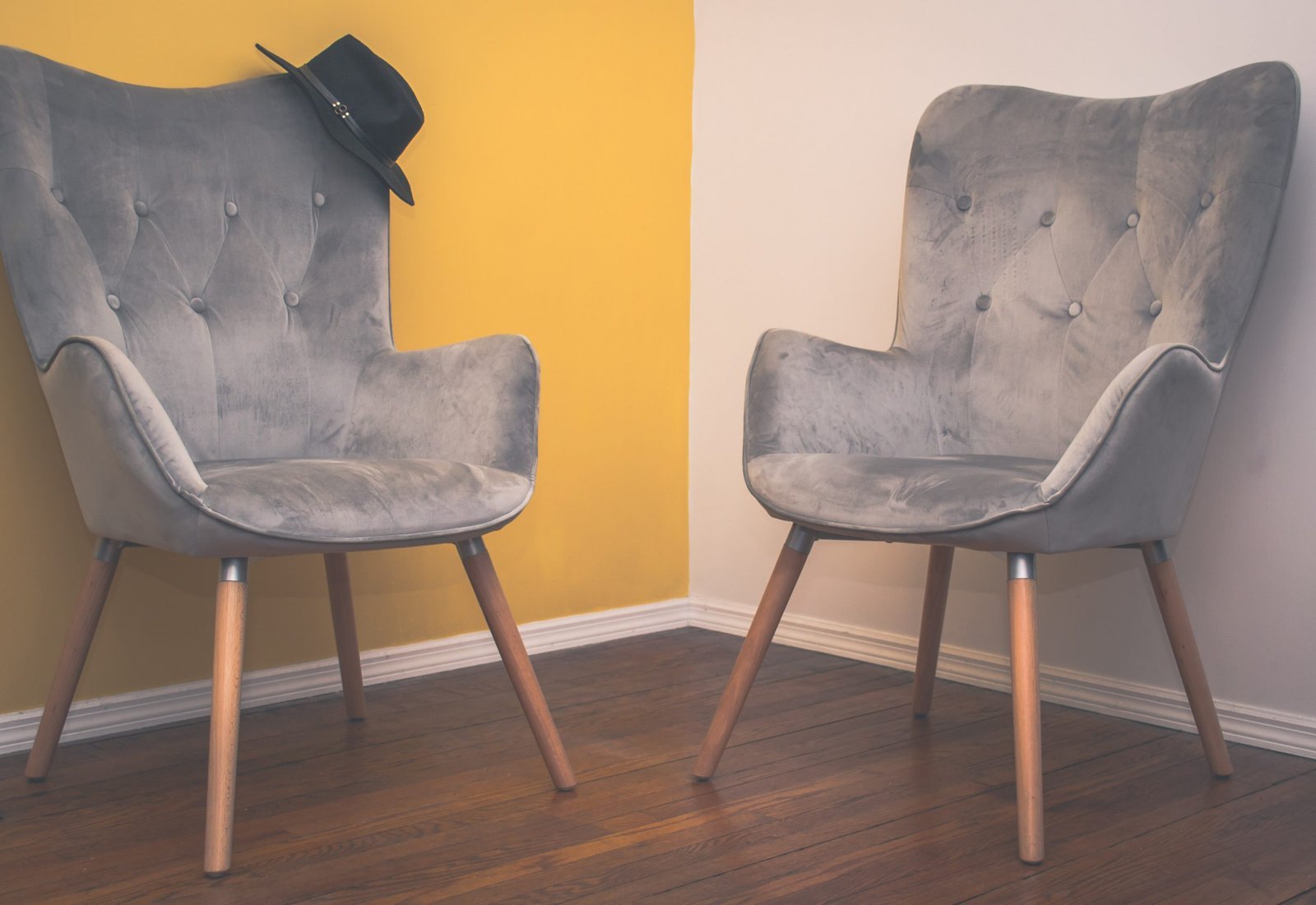 A person sitting in one chair during a two chairs therapy session.