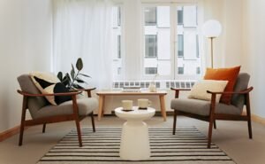 Two empty chairs facing each other in a clean and modern therapy office space.