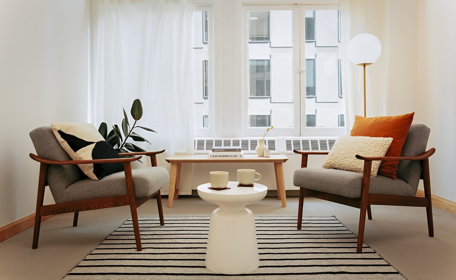 Two empty chairs facing each other in a clean and modern therapy office space.