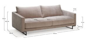 A modern three-seater sofa centered in a bright and spacious living room.