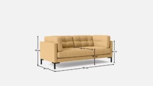 A modern three-seater sofa sits in a bright and spacious living room.