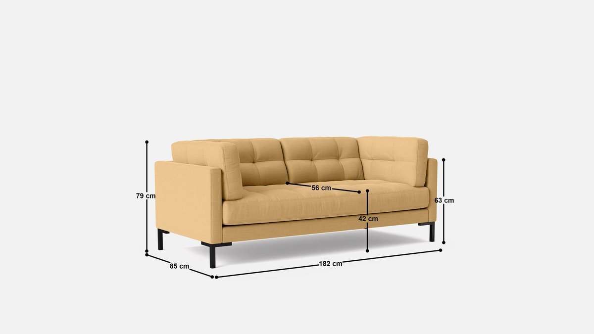 A modern three-seater sofa sits in a bright and spacious living room.