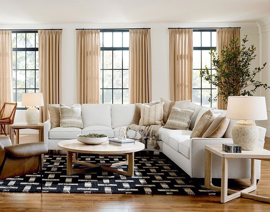 A modular sectional sofa sits in a modern, sunlit living room.