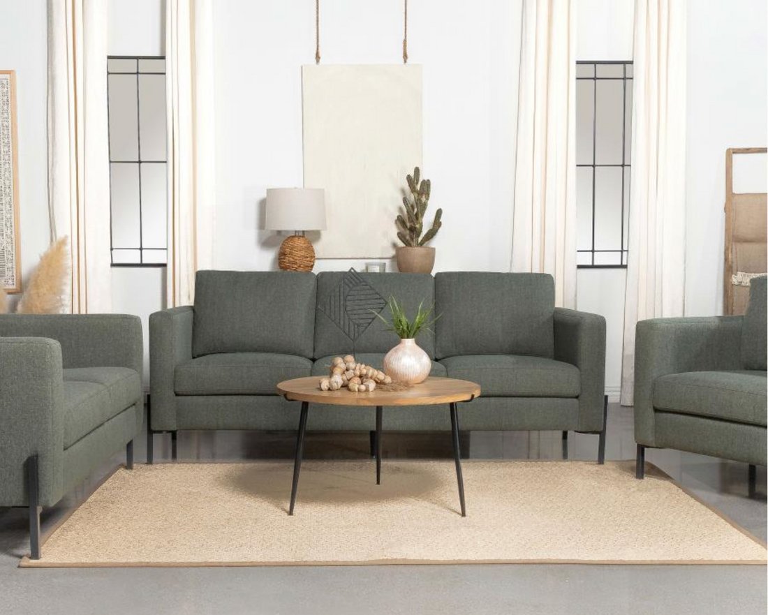 A customer testing a new couch for comfort inside a local furniture showroom.