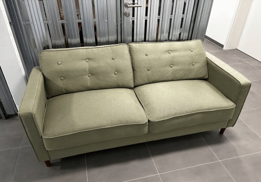 An interior designer discussing fabric choices for a new couch with a client.