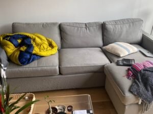 A comfortable modern couch in a sunlit living room representing where to buy furniture.
