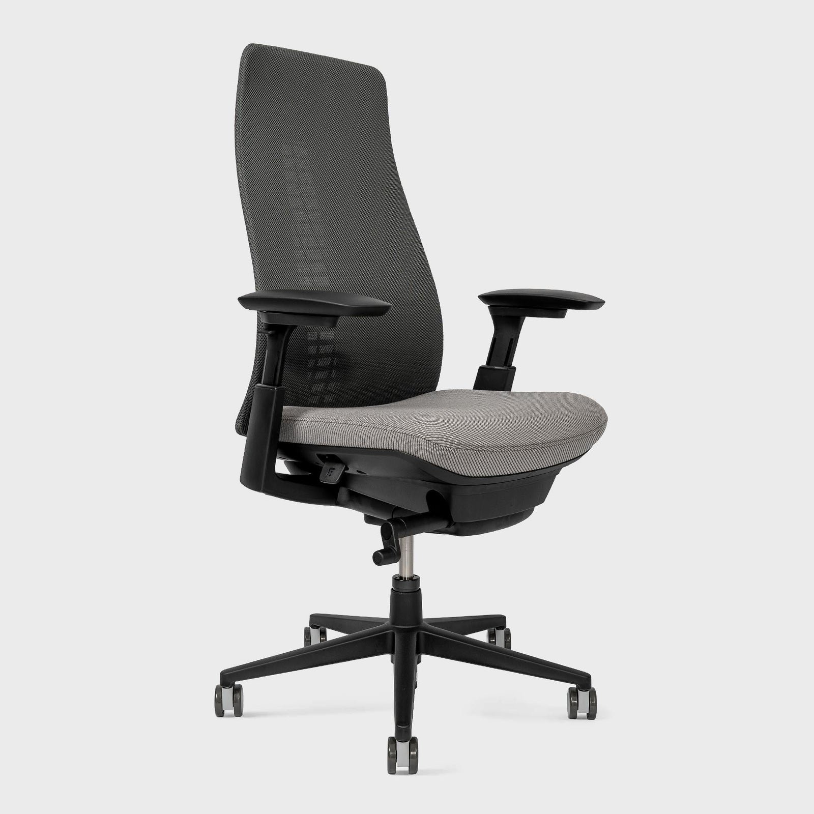 A person inspects a high-quality used office chair during a private sale transaction.