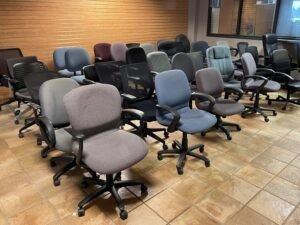 A comfortable ergonomic office chair displayed in a clean modern furniture showroom.