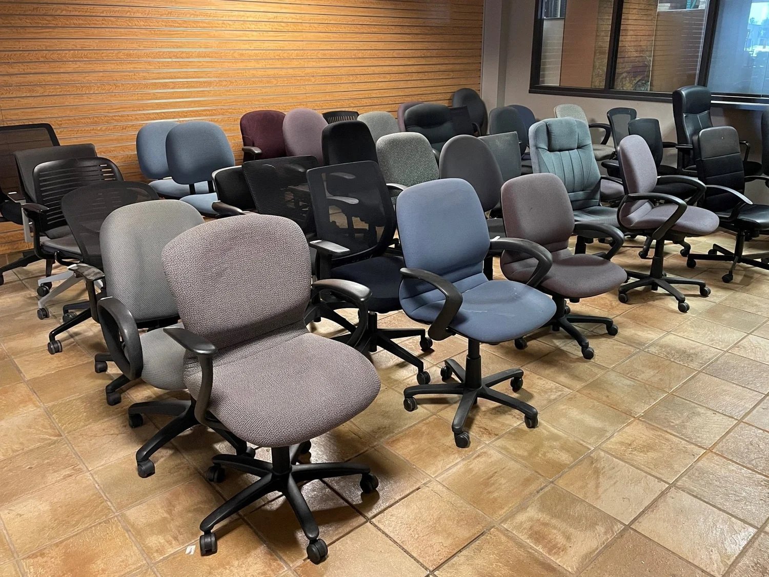 A comfortable ergonomic office chair displayed in a clean modern furniture showroom.