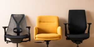 A modern ergonomic office chair sitting in a bright and professional home workspace.