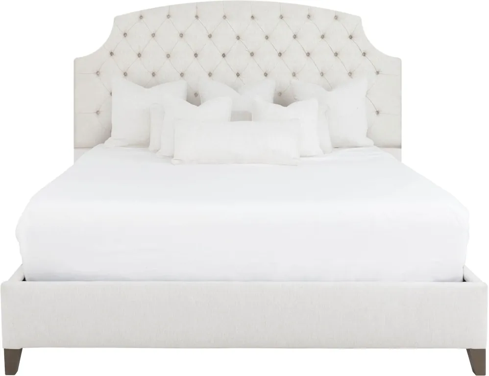 An accent chair and a low slipper chair displayed in a bright bedroom.