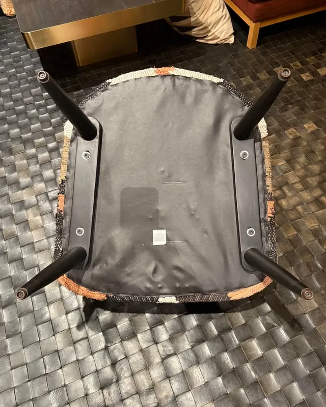 Adjusting a swivel plate under a chair to ensure proper balance and stability.
