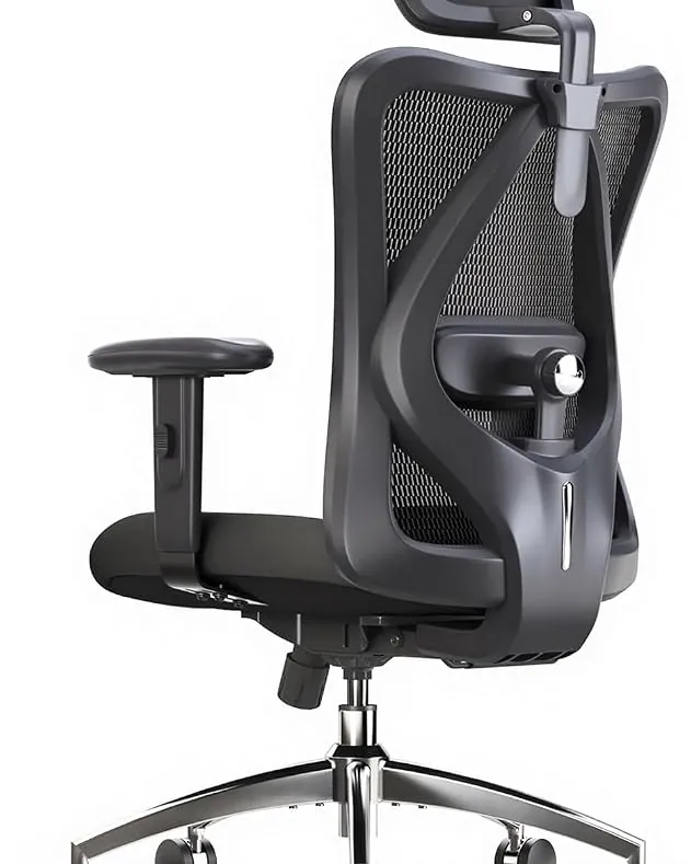 A black mesh office chair sitting in a warehouse storage aisle.
