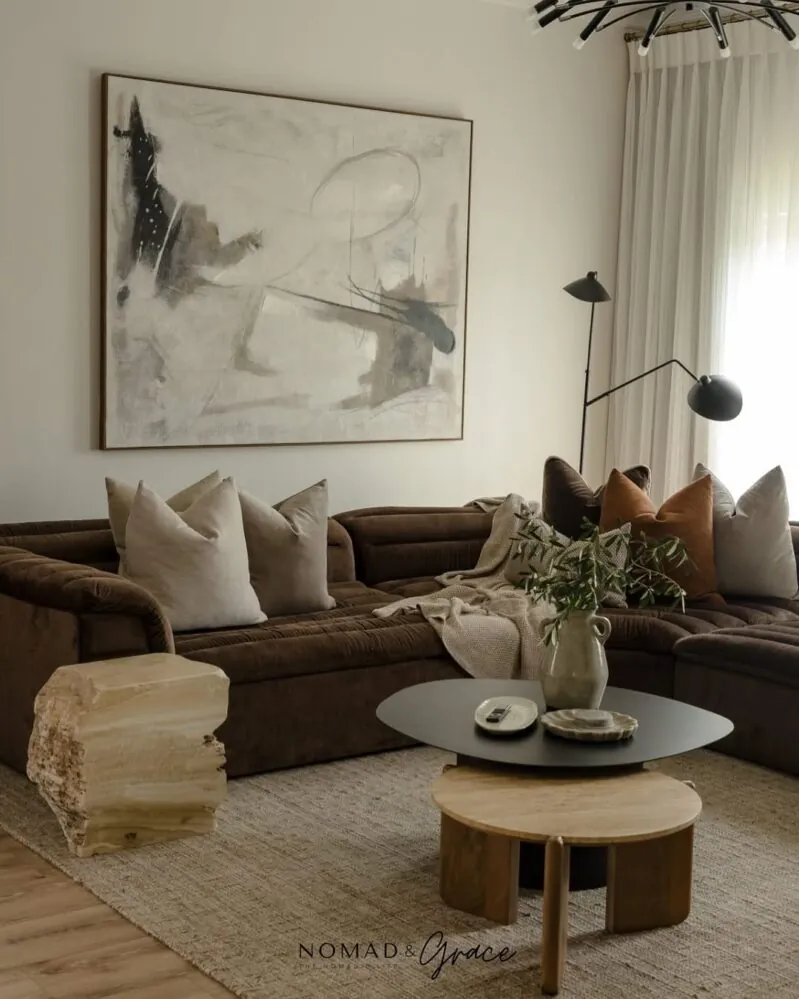 A brightened brown sofa updated with seasonal accessories in a clean living room.