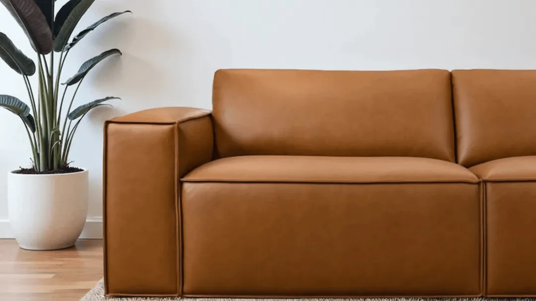 Checking the fabric care tag on a sectional couch for cleaning instructions.