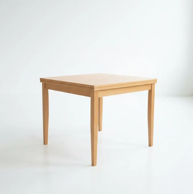 A clean wooden dining table surface captured with soft natural light and detail.