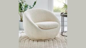 A comfortable armchair placed in a bright bedroom, perfect for relaxing and reading.