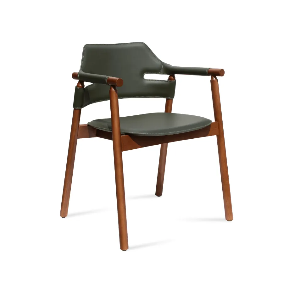 A comfortable Womb chair with an ottoman situated in a quiet reading corner.