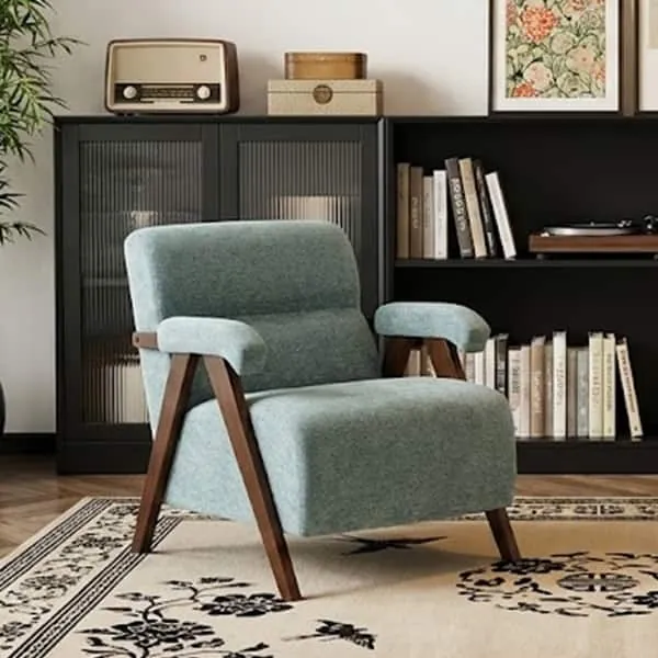 A compact mid-century modern side chair placed neatly in a small apartment corner.