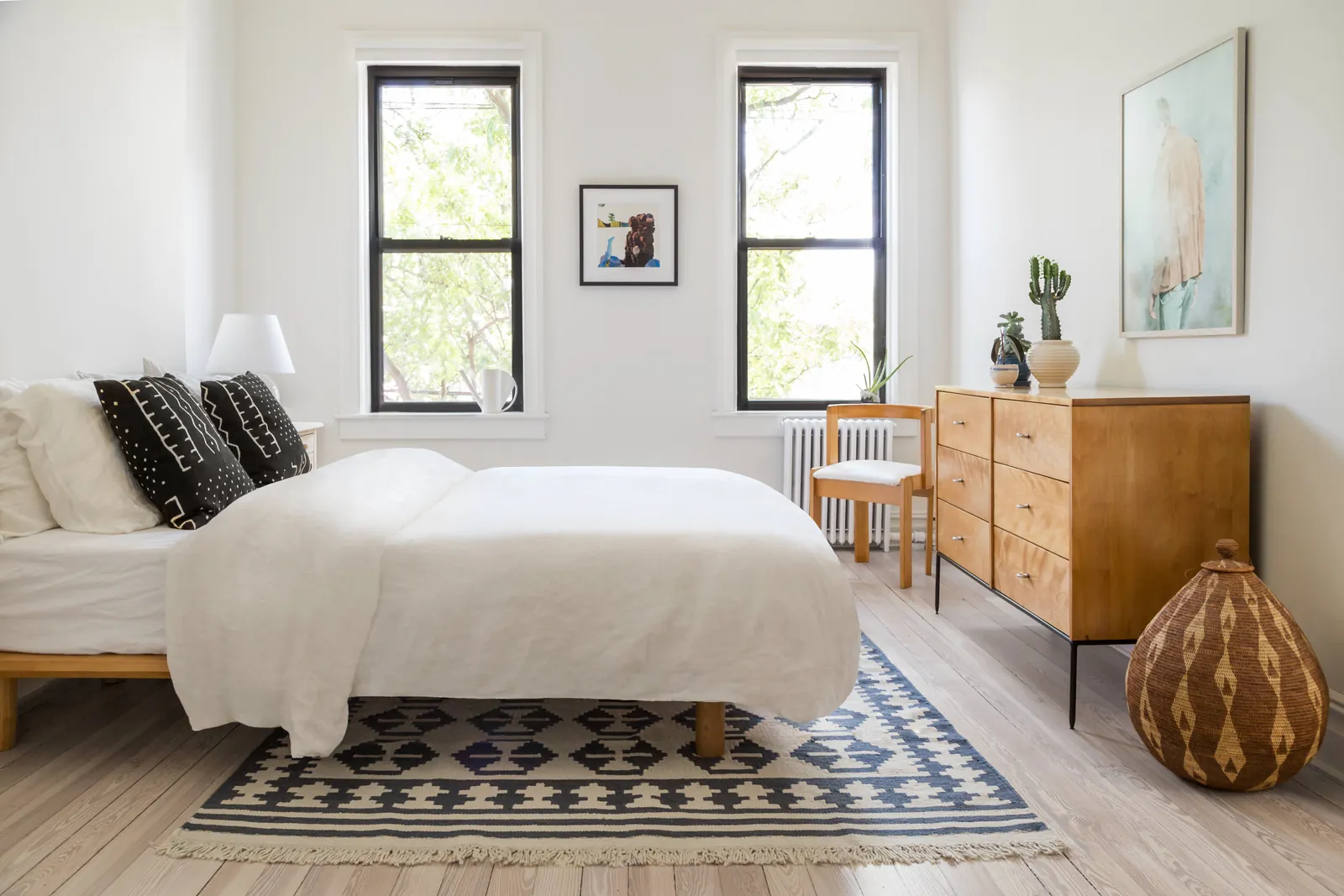 A compact slipper chair is tucked away to maintain a clear path in the bedroom.