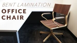 A custom-made rolling chair stands in a sunlit workshop, showcasing high-quality caster wheels.