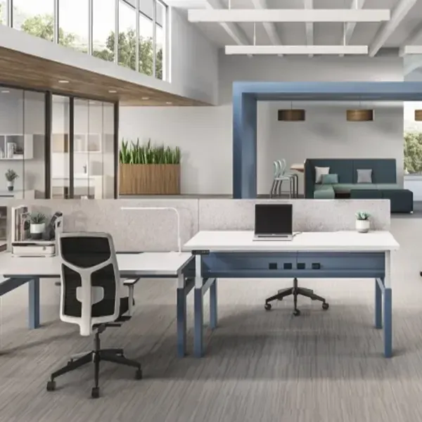 Designer using a tape measure and floor plan to plan custom office furniture.