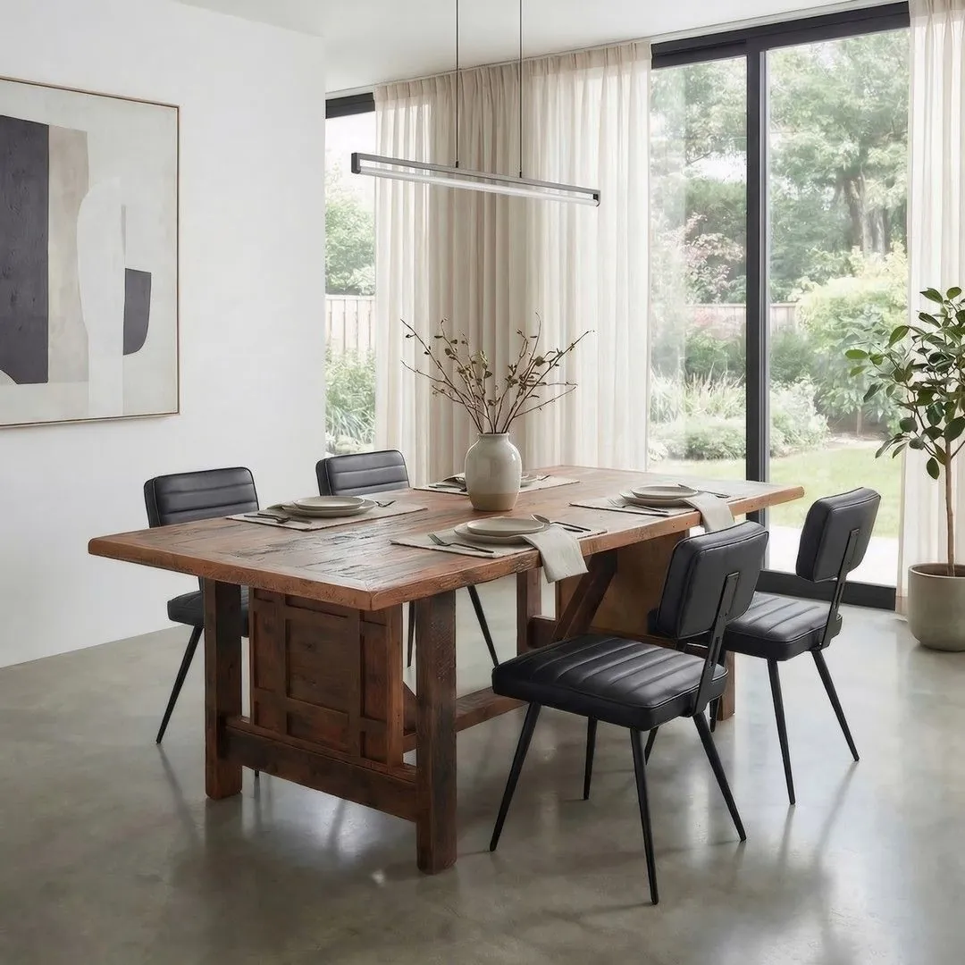 Different styles of dining room chairs arranged around a modern table.