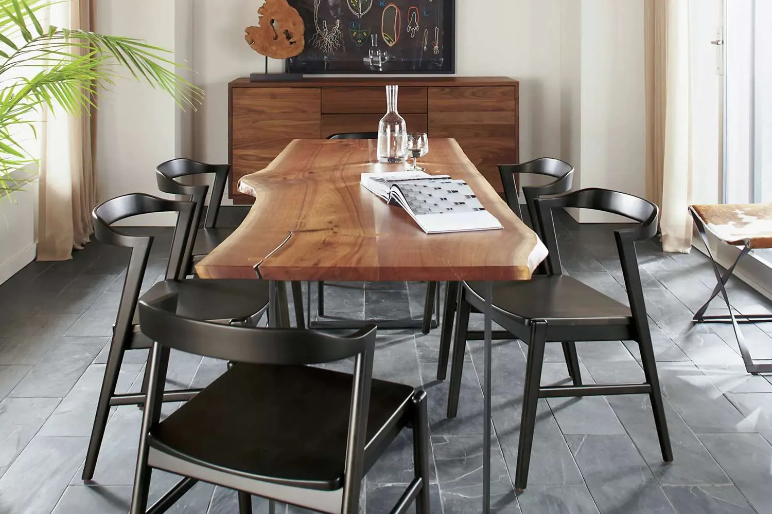 A dining chair blocked by a thick table apron in a cozy room.