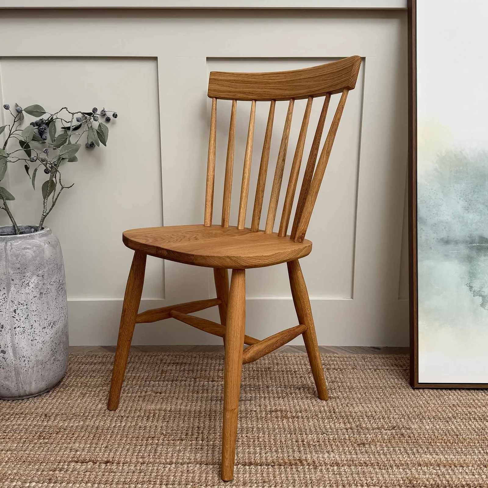 A dining chair placed too close to a thick table apron limiting legroom.