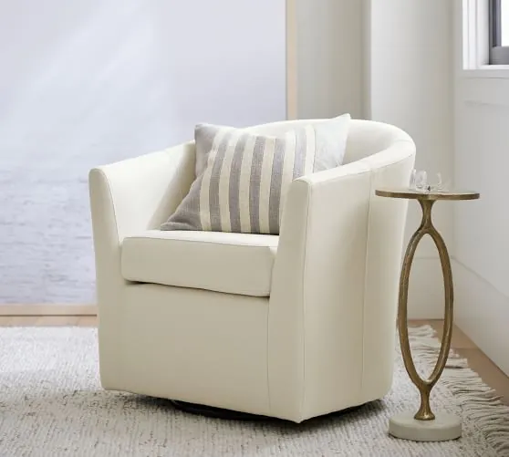 Diverse comfortable chairs for small spaces displayed in a modern furniture store showroom.
