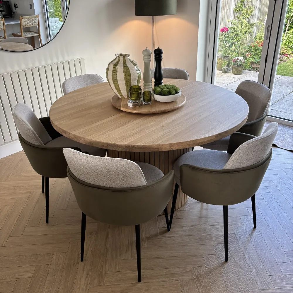 A durable distressed wood dining table with an extension leaf in a small apartment.