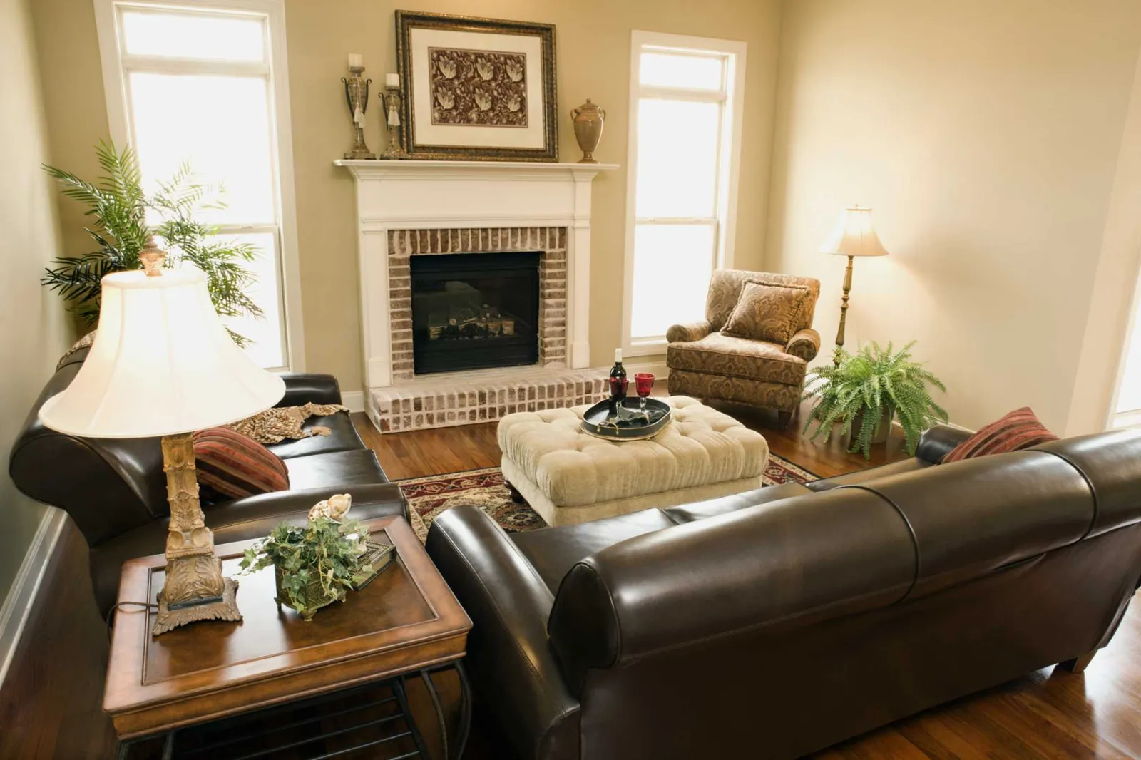 Essential tools for cleaning and styling a brown couch arranged on a table.