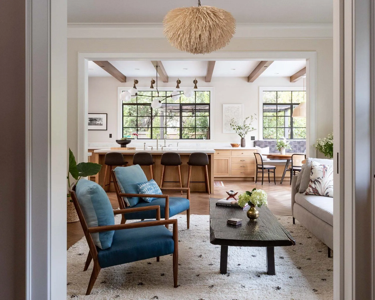 Expanding a modular dining table using a smooth track system in a modern home.