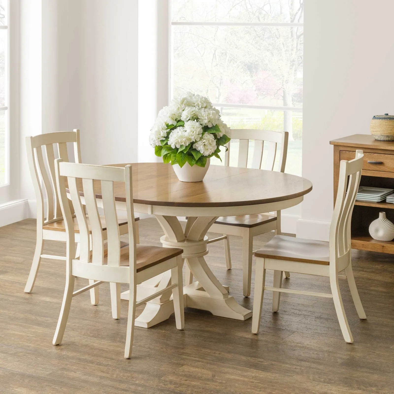 Flat-pack dining table parts and tools are laid out on a floor.