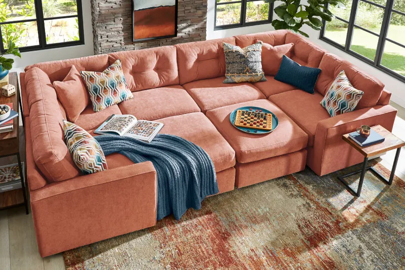 Four different modular sofa types arranged side by side in a bright loft.