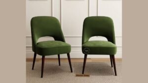 Four modern wooden dining chairs arranged around an oak kitchen table.