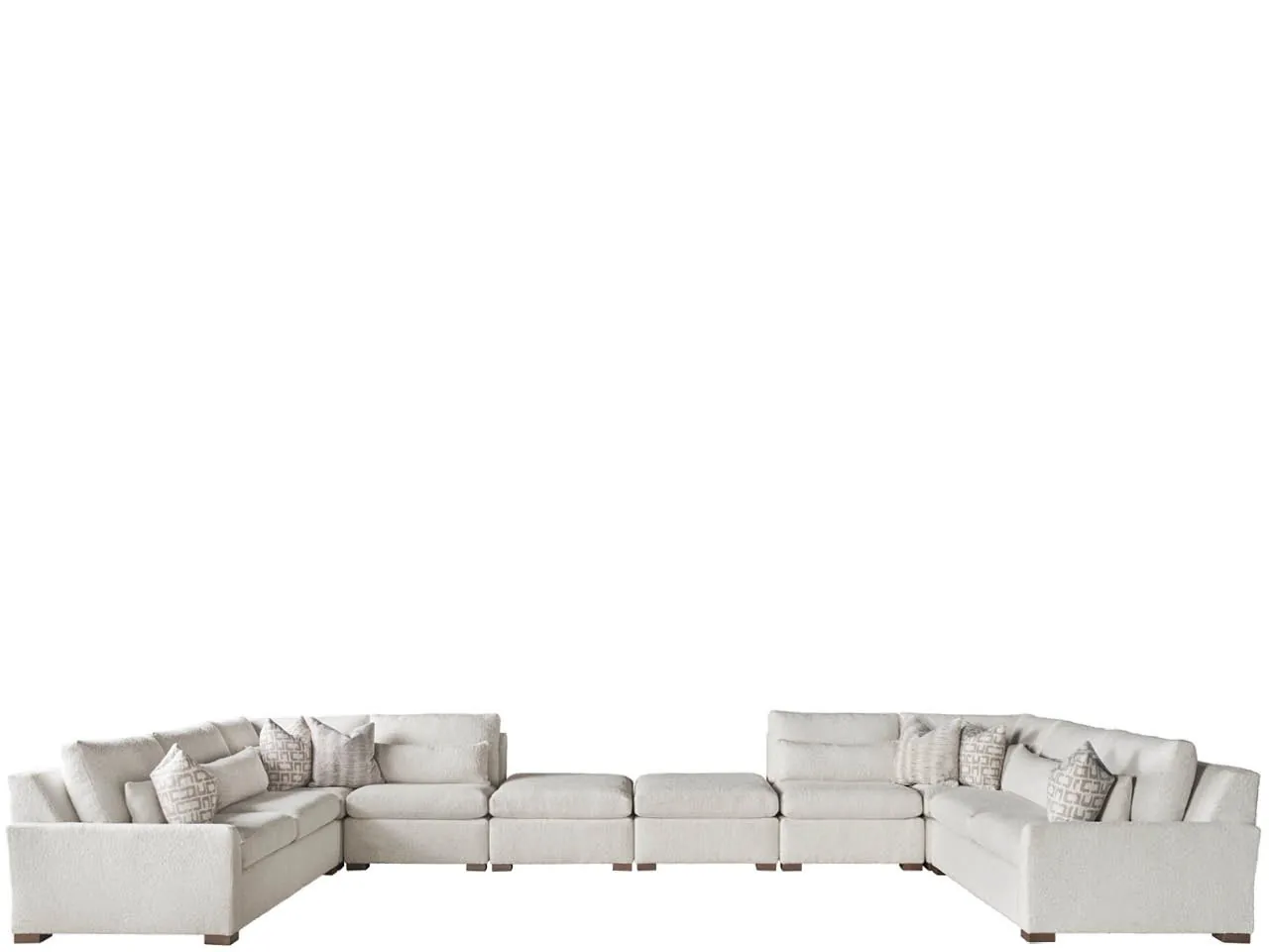 A hand presses down on a high-quality sectional cushion to test firmness.