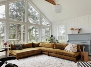 A large modern sectional sofa sits in a bright contemporary living room.